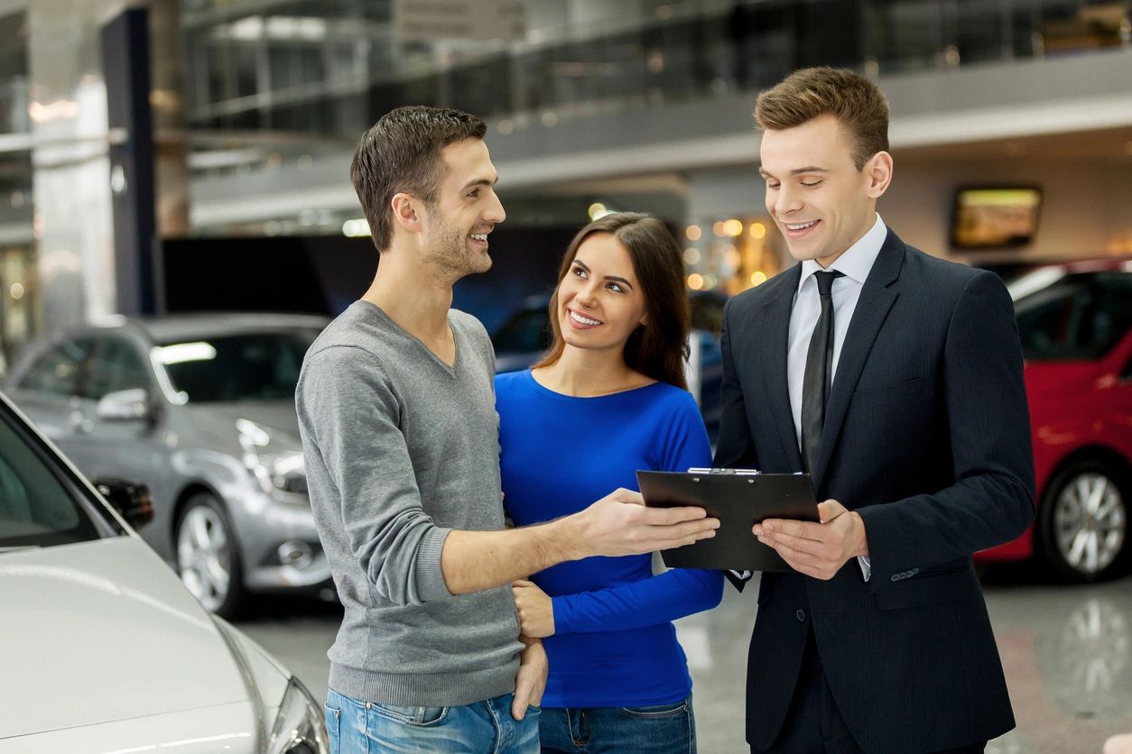 A man and woman talking to an agent.