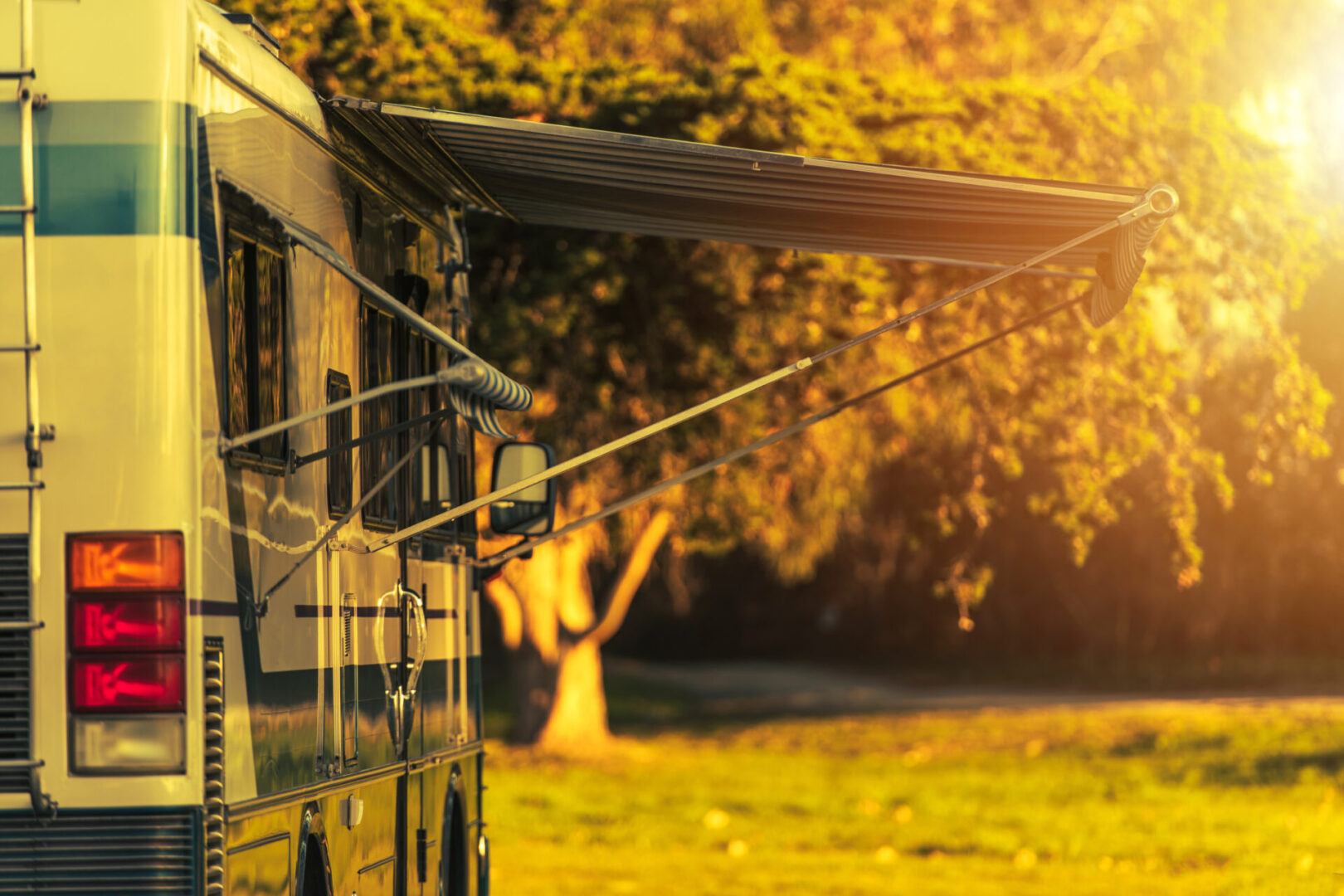Class A Recreation Vehicle Diesel Pusher Motorhome Camping Spot. Motor Coach in a RV Park During Sunny Summer Vacation Day.